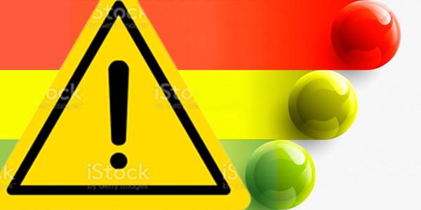 Yellow triangle with exclamation mark. Alert icon. Road warning sign. Attention hazard symbol. Red, yellow, and green balls to represent 3 work levels.