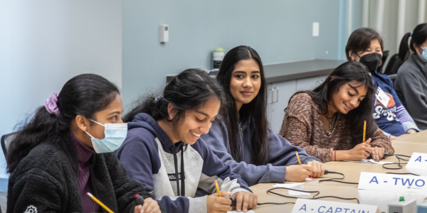 students at table competing